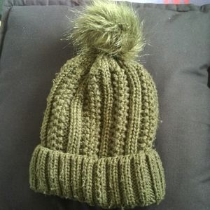 Green beanie with fluffy pom poms